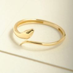 "Here's the Stylish Snake Stacking Ring by Christo! Our 14K Solid Gold Spiral Open Ring is perfect Stackable and Daily Spiral Open Ring for Girls. This Minimalist Index Finger Cuff Ring is designed as Premium Chick Index Finger Ring and 18K Knuckle Ring for her. This Dainty Stacked Ring is perfect Daily wear Ring as a Everyday Simple Ring design for women.  Our Stackable Wrapped Knuckle Band is perfect Motherly Gift Jewelry for mother, wife and mom. This Stylish Minimalist Cuff Ring is also grea Adjustable Minimalist Snake Ring, Minimalist Adjustable Open Snake Ring, Adjustable Minimalist Snake-shaped Rings, Minimalist Adjustable Snake-shaped Ring, Minimalist Adjustable Snake Shape Rings, Minimalist Bangle Rings For Gifts, Minimalist Yellow Gold Open Snake Ring, Minimalist Yellow Gold Snake Ring, Adjustable Open Ring Yellow Gold Bracelet