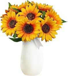 a white vase filled with lots of yellow sunflowers