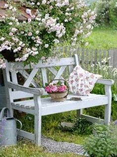 a wooden bench sitting next to a garden filled with flowers