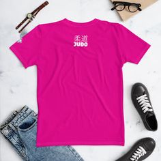 a pink t - shirt with the words make dout on it next to some shoes