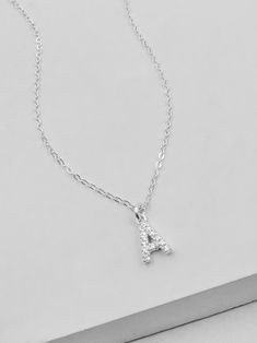 "This initial necklace is a perfect gift for your friend, families or bridal party! It's small and dainty, sparkles a ton and isn't over the top! Sterling silver letter on a sterling filled chain. Necklace comes with an additional 2\" extender. Letters measure approximately 6mm in height. The Following letters have a bail on the left hand corner and are angled when hanging: H, K, L, M, N, U, V, W, X, Y Please read my shop policies to learn more about the composition and proper care for each item Luxury Sterling Silver Initial Necklace Fine Jewelry, Cheap Sterling Silver Initial Pendant Name Necklace, Dainty Silver Initial Necklace For Birthday, Silver Charm Necklaces With Delicate Chain For Birthday, Silver Necklaces With Delicate Chain For Birthday, Silver Necklace With Delicate Chain For Birthday, Silver Delicate Chain Necklace For Birthday, Letter Necklace Silver, Silver Initial Necklace