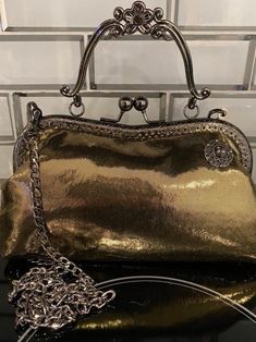 Vibrant gold clutch purse with black lining, black frame, feet and removable chain. Great for out on the town or casual wear. One of a kind product. Gold Clutch Evening Bag For Night Out, Gold Chain Crossbody Evening Bag, Gold Bag With Chain For Night Out, Gold Evening Bag For Night Out, Gold Metal Bag For Everyday Use, Gold Bag With Gold Chain For Night Out, Gold Bags With Gold Chain For Night Out, Elegant Gold Clutch With Metal Hardware, Gold Evening Bag With Metal Hardware