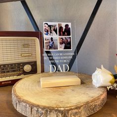 a wooden table with an old fashioned radio and photo on it