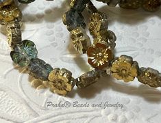 a close up of some beads on a white table cloth with lace in the background