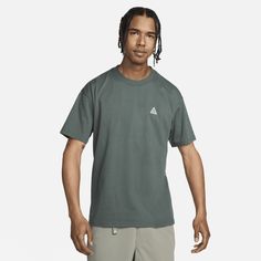 Loose, roomy, and outdoor ready, the Nike ACG T-Shirt keeps things comfy with a graphic repping "All Conditions Gear." This product is made with 100% sustainable materials, using a blend of both recycled polyester and organic cotton fibers. The blend is at least 10% recycled fibers or at least 10% organic cotton fibers. Nike Short Sleeve T-shirt For Outdoor Activities, Nike T-shirt For Outdoor Activities, Nike Casual T-shirt For Outdoor Activities, Nike Casual T-shirt For Outdoor, Casual Nike T-shirt For Outdoor Activities, Urban Relaxed Fit Top For Outdoor Activities, Urban Cotton Tops For Outdoor Activities, Outdoor Moisture-wicking Relaxed Fit T-shirt, Green Urban Outdoor Tops