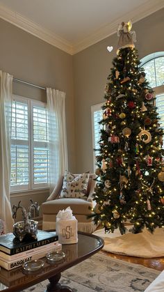 a living room with a christmas tree in the corner