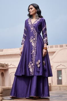 Purple silk angrakha featuring embroidered zari mor motifs highlighted with sequin work. Comes with plain sharara.
Components: 2
Pattern: Embroidered
Type Of Work: Zari, Sequin
Neckline: V-neck
Sleeve Type: Three quarter
Fabric: Silk
Color: Purple
Other Details: 
Overlap kurta panels with drawcord closure
Note: Dupatta worn by the model is not for sale
Occasion: Sangeet,Mehendi and Haldi - Aza Fashions Angrakha With Sharara, Purple Dress Indian, Indowestern Outfits Wedding Women, Plain Sharara, Angrakha Suit, Angrakha Style Kurti, वेस्टर्न ड्रेस, Sharara For Women, Embroidered Peacock