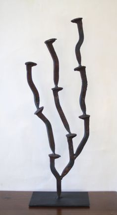 a metal sculpture on top of a wooden table