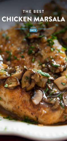 chicken marsala with mushrooms and parsley on a white plate