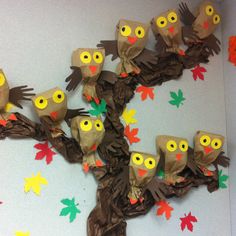 a group of owls sitting on top of a tree