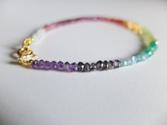 This rainbow bracelet has a great variety of natural gemstones. They are : Ruby, Iolite, Peridot, Citrine, Carnelian, Apatite , green Onyx , pink Tourmaline, Aquamarine and Apatite A gorgeous fusion of colors in this multi stone precious bracelet. A riot of vivid colors in ombre design I chose and lined the gemstones to obtain this unique shaded colorful precious bracelet. It will be beautiful alone or together with other gemstones stacking bracelets The gemstone beads are strung on the highest Rainbow Gemstone Beads Bracelets For Jewelry Making, Spiritual Multicolor Faceted Beaded Bracelets, Rainbow Multi-stone Bracelets As A Gift, Multicolor Faceted Spiritual Bracelets, Multicolor Gemstone Beads, Rainbow Gemstone Beads Bracelet, Multicolor Faceted Rondelle Bracelets, Multicolor Faceted Crystal Bracelet As Gift, Multicolor Rondelle Bracelets For Jewelry Making