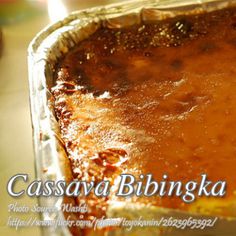 a close up of a pie in a pan on a table with the words cassava bibingka above it