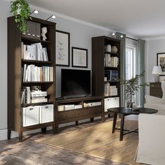 a living room filled with furniture and a flat screen tv on top of a wooden entertainment center