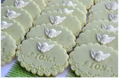 some cookies with white icing are sitting on a table and there is no image here to provide a caption for