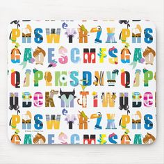 a mouse pad with colorful letters and animals on the front, in multicolors