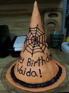 a birthday cake that is shaped like a witch's hat with the words happy birthday viada written on it