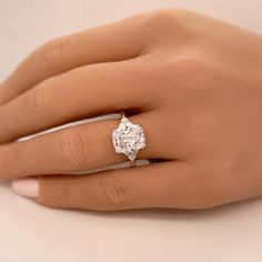 a woman's hand with a diamond ring on it