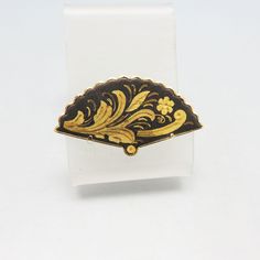 This handsome goldplated and enameled metal, fan shaped brooch dates to the 1960s.  It measures 1 inch tall and 1 7/8th wide and is in excellent condition. It would be lovely at the neck of a blouse or as a scarf pin. There is a locking safety clasp and the piece is unsigned .  We will send this to you in a lovely gift box for easy gift giving. For other fantastic pieces of vintage silver, costume jewels, bolo ties and more, please check out my store, www.etsy.com/shops/PANDPF Collectible Gold Enamel Pins, Vintage Gold Enamel Pin For Wedding, Gold Enamel Brooch Pin, Gold Vintage Enamel Pin For Wedding, Antique Gold Enamel Brooches, Antique Gold Enamel Pin For Formal Occasions, Vintage Gold Enamel Lapel Pin, Vintage Gold Enamel Brooches, Vintage Yellow Gold Enamel Pin Collectible