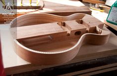 a wooden guitar being built on a workbench