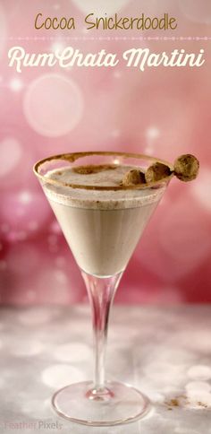 a drink in a martini glass sitting on top of a table with the caption cocoa snickkerboodlee