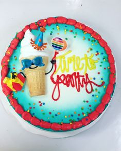 there is a birthday cake with an ice cream cone and sunglasses on it that says turetes gravity