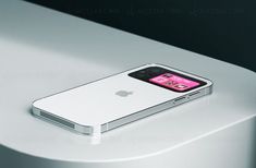 an iphone sitting on top of a white table