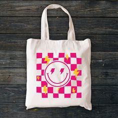 "Aesthetic Smile Tote Bag, Checkered Summer Tote Bag, Trendy Cool Canvas Bag, Positivity Bag, Tumblr Tote Bag, Canvas Bag, Zippered Tote Bag Welcome to ZeeShirtUS! I am happy to see you in my shop. My main purpose is to meet you with a high-quality product. The regular and zippered tote bags are perfect for just about anything. Grocery bag, school bag, beach bag, a beautiful fashion bag all year round, etc. The design is only printed on one side of the bag.  How To Order 1. Please, check and rev Trendy Rectangular Canvas Bag, Trendy Square Canvas Bag, Trendy Large Capacity Bags For Gifts, Everyday Tote Bags With Graphic Print, Graphic Print Tote Bag For Everyday Use, Trendy Bag With Graphic Print For Gift, Everyday Graphic Print Tote Bag, Trendy Bags With Graphic Print For Gifts, Trendy Graphic Print Bag For Gifts