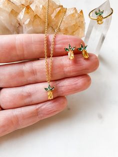 "ABOUT THIS PIECE:  Pineapple set, includes a dainty & vibrant pineapple necklace on a delicate 16\" cable chain, lobster clasp closure and 2\" extender, matching adjustable ring and tiny (1/2\") studs. 14K gold vermeil. Vermeil is a tarnish resistant material that has a 925 sterling silver base metal and is coated in 2.5 micron thickness of 14k gold/rose gold/silver.  Here are the other products in my shop:  https://www.etsy.com/ca/shop/RubyBlueCo SHIPPING: Please read my \"Shop Announcement\" for details on shipping. If your order is a gift, we are happy to directly ship it to the recipient's address, just be sure to enter their address & not yours.   PACKAGING: Your item will arrive beautifully packaged in an eco-friendly blue soft microfiber pouch.  GIFT WRAP OPTION: I offer free gift Pineapple Rings, Pineapple Jewelry, Pineapple Necklace, Base Metal, Cable Chain, Adjustable Rings, Layered Necklaces, Gold Vermeil, Free Gifts