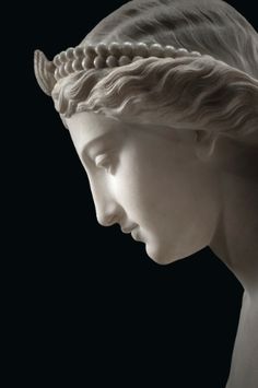 a statue of a woman's head with her eyes closed