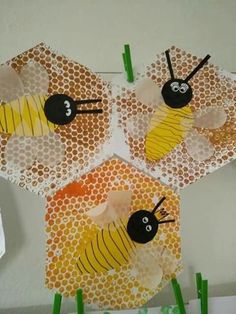 three bees on honeycombs made out of paper