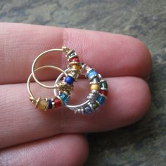 bejeweled-- goldfill or niobium tiny hoop set of 2-- mix or match-- handmade by thebeadedlily on etsy. $34.00, via Etsy. Nose Ring Hoop, Helix Hoop, Cartilage Hoop, Earring Handmade, Nose Rings Hoop, Nose Rings, Nose Ring Stud, Funky Jewelry, Beaded Hoops