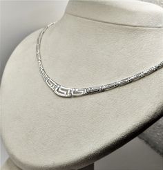 Buy a unique Handmade Ancient Greek Key Meander Silver Necklace For Women | Discover a large collection of Ancient Greek Jewelry in our ON-LINE shop | FREE SHIPPING all over the world This product is a beautiful silver 925 Necklace inspired by the Ancient Greek Key pattern-Meander.A meander or meandros (Greek: Μαίανδρος) is a decorative border constructed from a continuous line, shaped into a repeated motif. Such a design is also called the Greek fret or Greek key design. Visit my Home Page: https://www.etsy.com/shop/GreekHistoryArt Type We offer 1 type of necklace  Size Length:Adjustable Width:0.8cm(0.32 inches) IF YOU WANT OTHER SIZE PLEASE CONTACT US Material All my products are pure Sterling Silver. This necklace is Shiny Silver and degrade. If you wish to see more products with Meande Classic Silver Necklace Stamped 925, Classic Silver Engraved Necklace, Classic White Gold Necklace Stamped 925, Classic Handmade Silver Necklaces, Silver Necklace With Sterling Silver Clasp For Anniversary, Anniversary Silver Necklace With Sterling Silver Clasp, Silver Engraved Necklace Fine Jewelry, Fine Jewelry Silver Engraved Necklace, Classic Sterling Silver Necklace Stamped 925