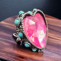 Add some extra sparkle to your look with this pink glass rhinestone ring featuring faux turquoise accents. The adjustable cuff style makes it a perfect fit for anyone. Painted Hats, Silver Chain For Men, Buckles Fashion, Turquoise Accents, Rhinestone Ring, Stone Heart, Pendant Rings, Pendant Bracelet, Pink Glass