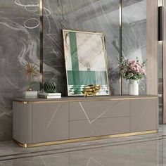 an elegant console with gold accents and marble walls