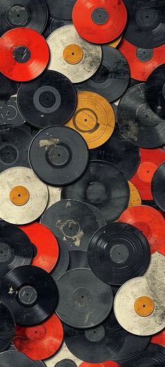 many different colored and black records are stacked together