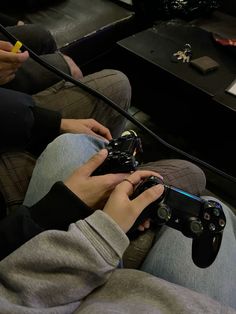 two people sitting on a couch playing video games