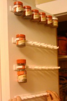 an image of spice rack with jars on the top and bottom shelves above it that are labeled use mop holes to store spices on the inside of a cabinet door