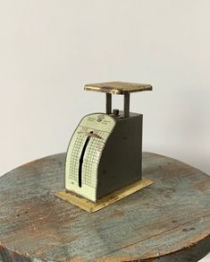 a small scale with a clock on top of it