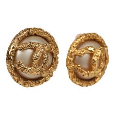 These 93A Chanel Lava CC and Pearl Earrings have a white faux pearl base overlayed with 24K gold plated metal and clip on closure.Origin: FranceCondition: Vintage; Mint - Earrings show signs of tarnishing.Accompanied by: Chanel boxMeasurements: 1.25" x 1.25" Vintage Chanel Earrings, Mint Earrings, Faux Pearl Earrings, Chanel Earrings, Quality Handbags, Gold Pearl Earrings, Chanel Vintage, Chanel Jewelry, Best Bags