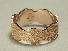 a close up of a gold ring on a table