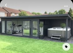 a backyard with a hot tub and exercise equipment