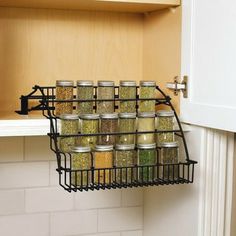 a rack with spices in it hanging from the wall