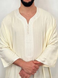 Mens Moroccan Thobe - Cream |djellaba, Jubbah, Beautiful quality with a lovely soft feel and texture.  Beautiful quality with a lovely soft feel and texture. A luxurious and sophisticated variation of the traditional North African garment. Crafted from high-quality linen, this garment combines the timeless elegance of a kaftan with the breathability and comfort of premium linen fabric. The standout feature of this thobe is the use of premium linen, a natural and lightweight fabric that is highly breathable and comfortable.  The design of the thobe retains the classic elements, with a long, loose-fitting silhouette that drapes gracefully from the shoulders to the ankles. Brand new, with original personal wrapping. We are known to many for our extensive Moroccan clothing collection. Colours: Bohemian Beige Kurta For Eid, Traditional Beige Long Sleeve Kaftan, Traditional Long Sleeve Beige Kaftan, Traditional Long Beige Thobe, Beige Long Thobe For Eid, Bohemian Long Sleeve Agbada For Eid, Beige Long Sleeve Kaftan For Eid, Beige Dabka Kaftan For Eid, Traditional Beige Long Sleeve Tunic