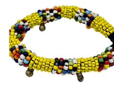 This beautiful bracelet can be worn on its own or layered with some of your other favorite pieces. It adds a pop of color to any outfit. Details: Push button clasp. Size: length of beaded portion: ~ 7.25" (18 cm), end to end: 8" (20 cm), widest portion ~1/4" (0.6 cm) Material: seed beads with brass accents and button clasp Multicolor Hand-strung Beaded Bangle, Hand-strung Multicolor Beaded Bangle, Multicolor Tiny Beads Bangle, Colorful Beaded Bohemian Stretch Bracelet, Colorful Bohemian Beaded Stretch Bracelet, Multicolor Spacer Beads Wrap Bangle Bracelet, Multicolor Spacer Beads Wrap Bracelet, Multicolor Spacer Bead Wrap Bangle Bracelet, Festival Multicolor Braided Bracelets With Tiny Beads