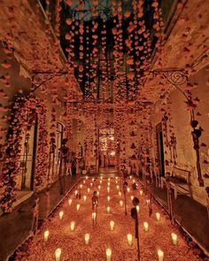 many candles are lit in the middle of a room with an elaborate ceiling and chandelier