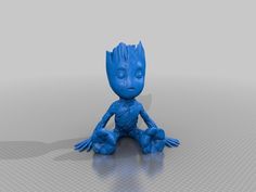 a blue baby groote sitting on the ground with his hands up and eyes closed