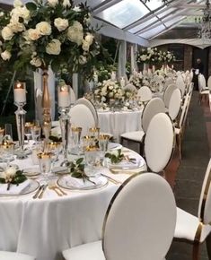 an image of a table set up for a formal function with flowers and candles on it