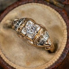 an antique diamond ring sits in a box