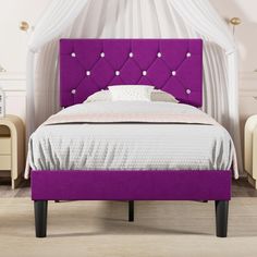 a bed with purple upholstered headboard and foot board