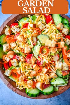 a salad with carrots, cucumbers and shredded cheese in a wooden bowl